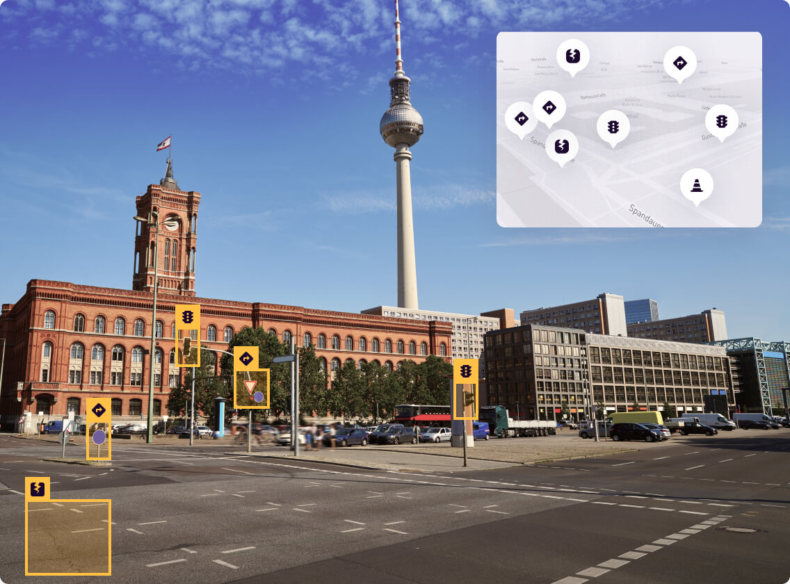 A street scene with road users and roadside assets detected and outlined by Peregrine Vision