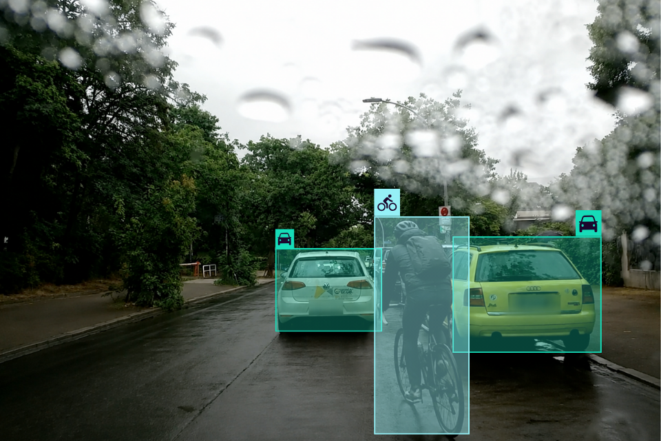 Harsh braking behind a cyclist on a wet road in heavy rain